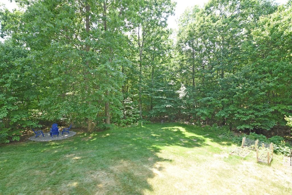 253 Pommogussett Road Rutland, MA 01543 - Photo 24 of 25 a backyard of a house with table and chairs