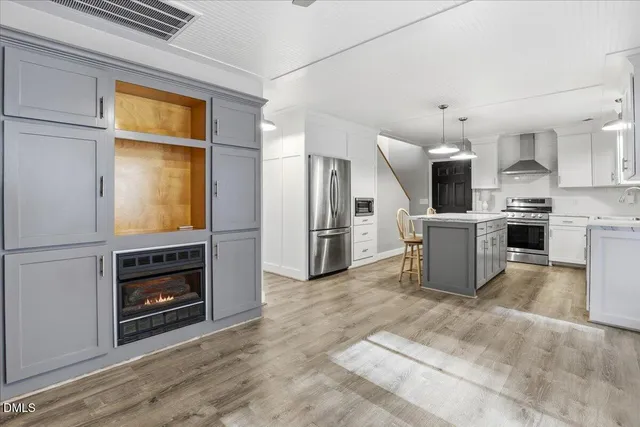 a kitchen with refrigerator and oven