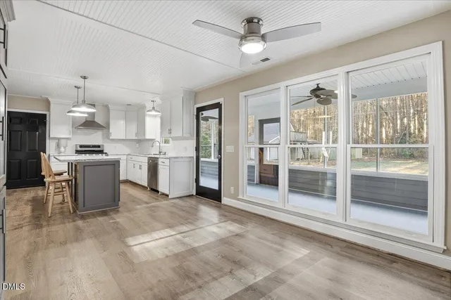 a large kitchen with cabinets and stainless steel appliances