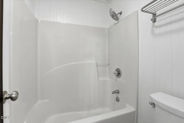 a bathroom with a bathtub and a toilet