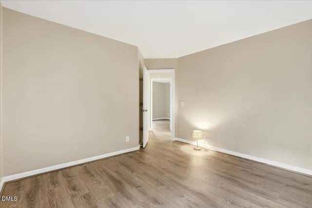 a view of an empty room and wooden floor
