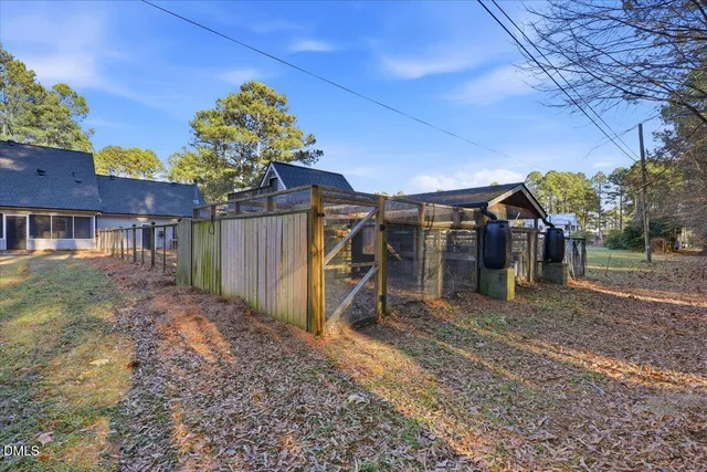 a view of a house with a yard and a garage