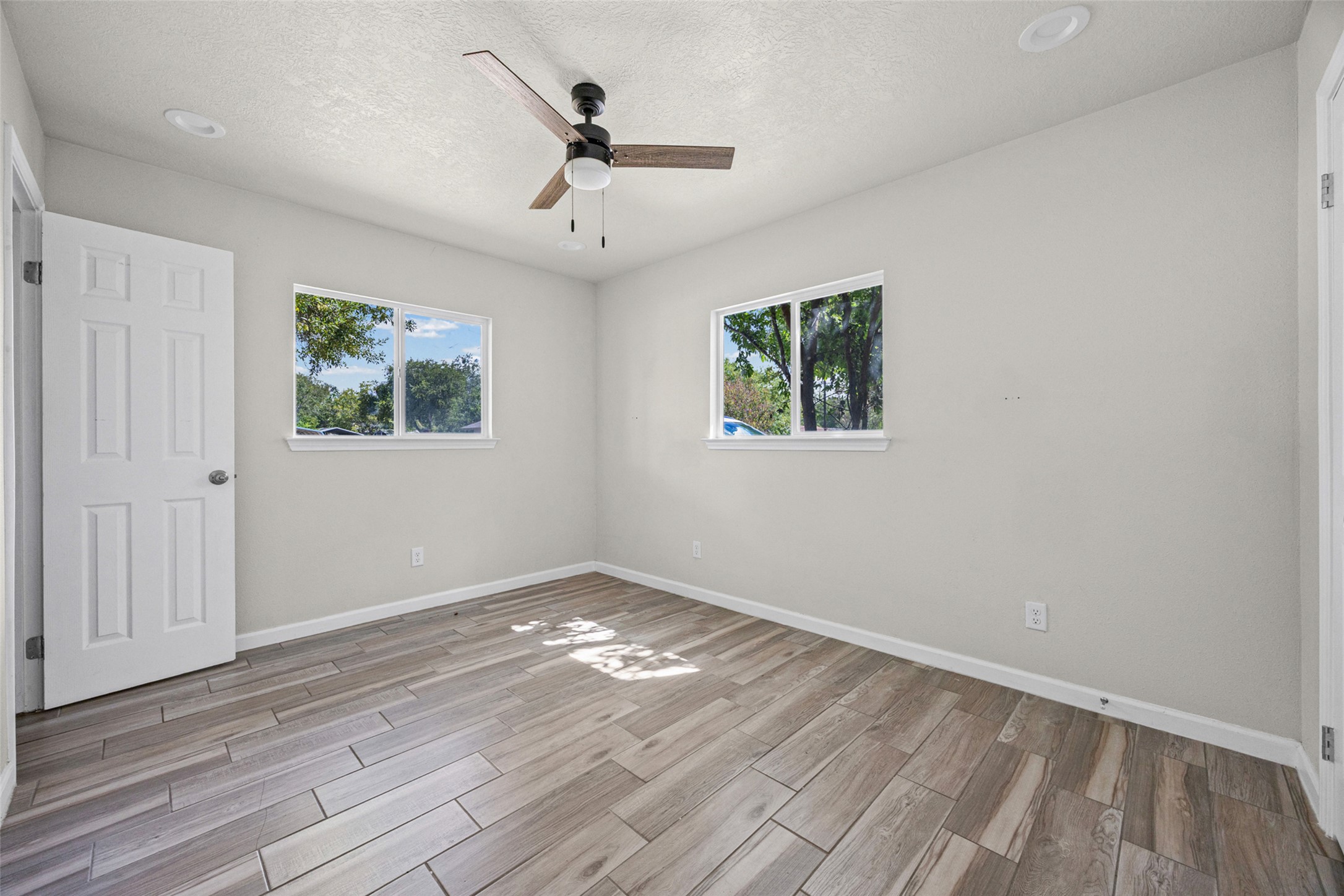 1531 Lahn Road New Braunfels, TX 78130 - Photo 10 of 33 Plank flooring and multiple windows enhance this versatile living space.