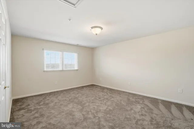 a view of a livingroom with a ceiling fan & entryway