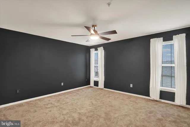 an empty room with a empty space and windows