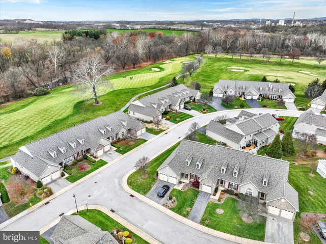 an aerial view of a house with garden space and ocean view