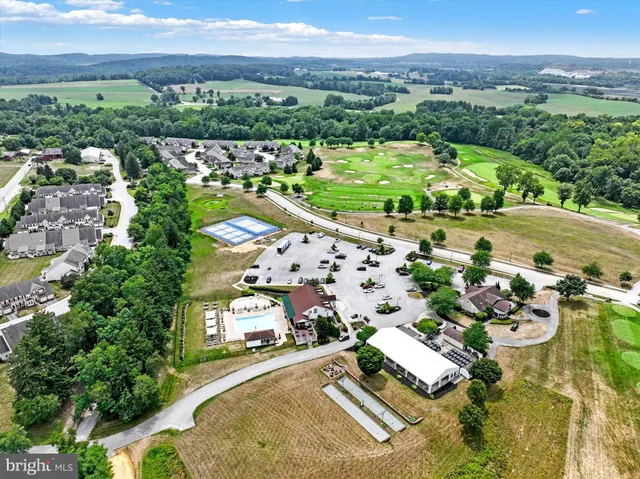 an aerial view of a city with lots of residential buildings ocean and mountain view in back