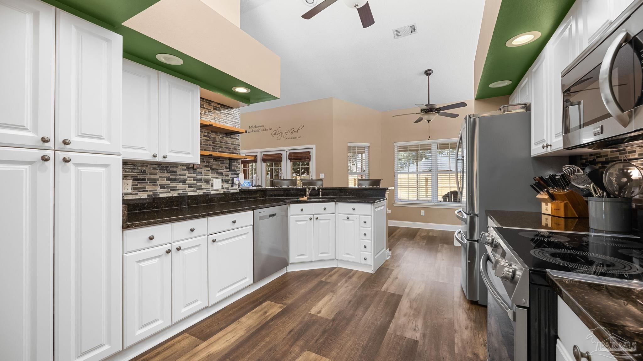 10305 Nightwind Circle Cantonment, FL 32533 - Photo 20 of 46 White cabinets, granite countertops, SS suite.