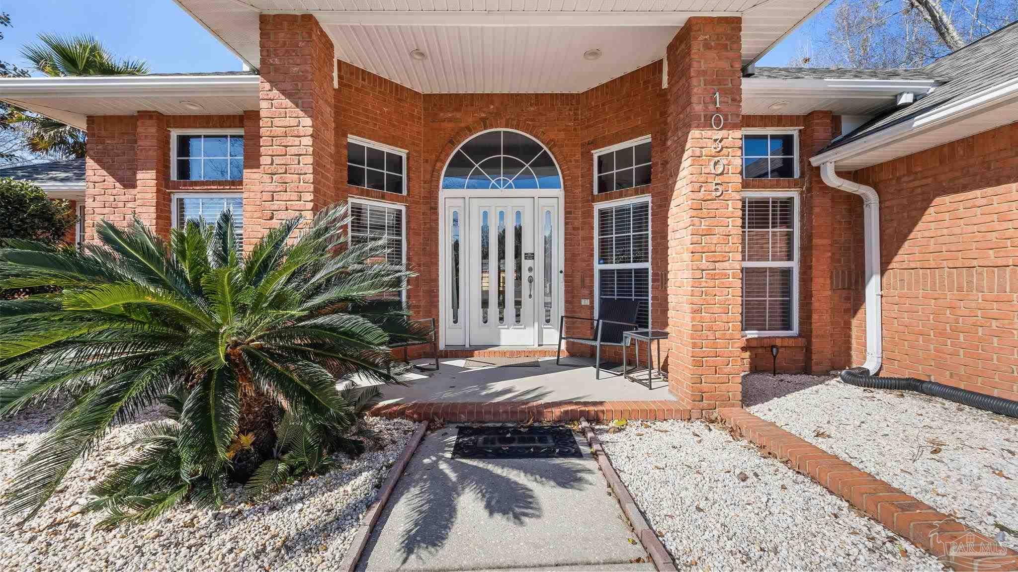 10305 Nightwind Circle Cantonment, FL 32533 - Photo 2 of 46 Covered porch and double doors with transom.