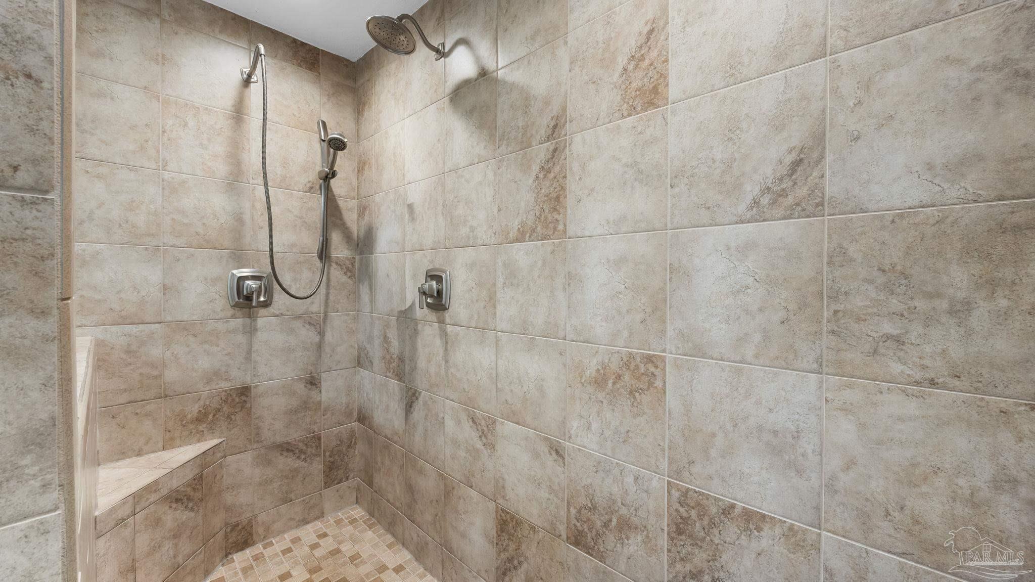 10305 Nightwind Circle Cantonment, FL 32533 - Photo 25 of 46 Updated tiled walk-in shower with bench.