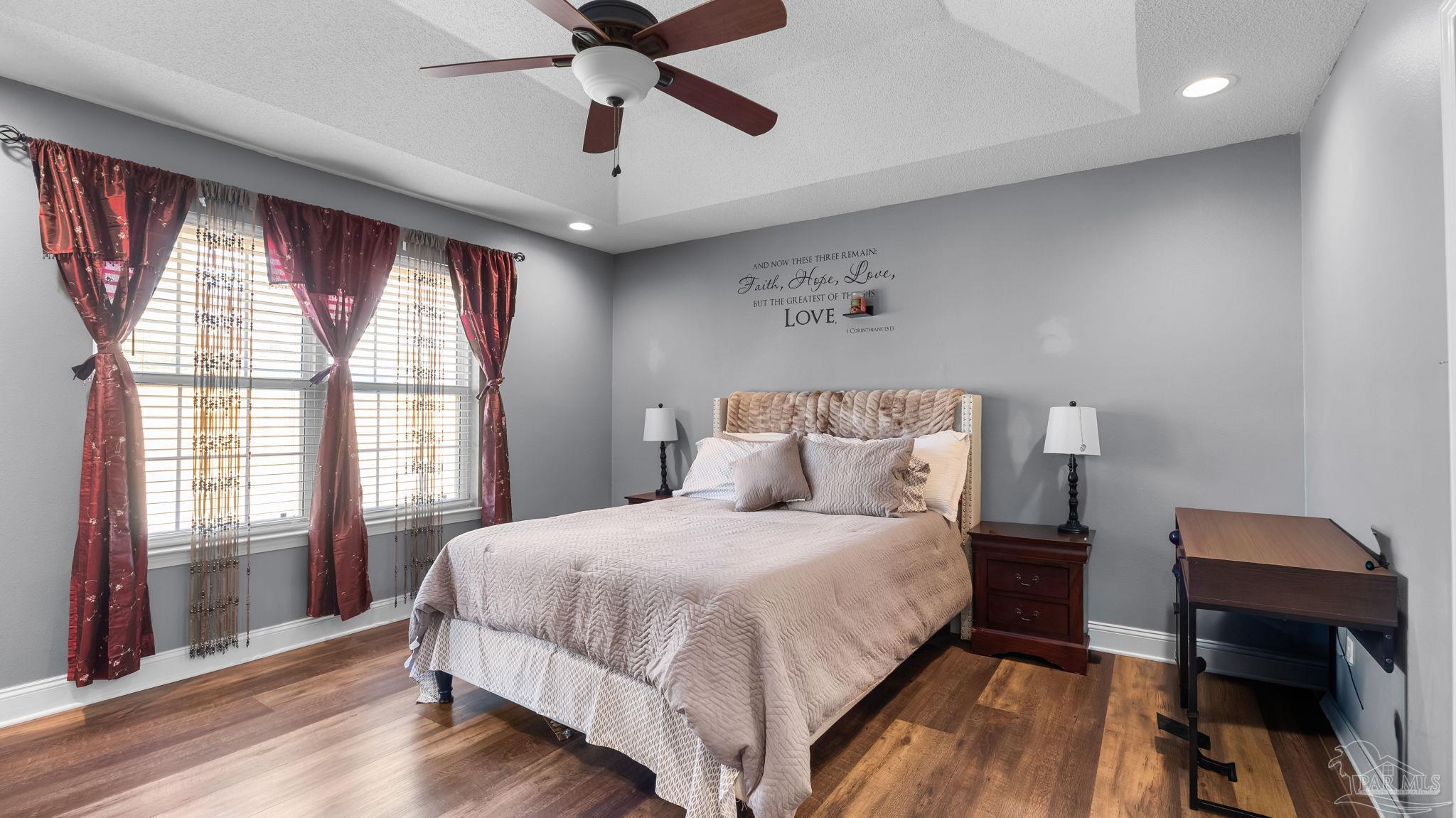 10305 Nightwind Circle Cantonment, FL 32533 - Photo 39 of 46 Light-filled primary bedroo with multiple windows.