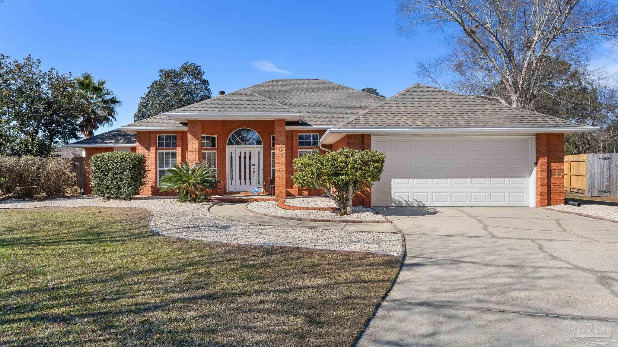 10305 Nightwind Circle Cantonment, FL 32533 - Photo 4 of 46 Clean landscaping and two-car garage frontage.