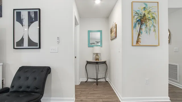 a view of a hallway with furniture and closet