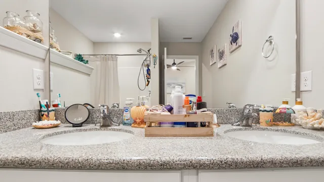 a bathroom with a granite countertop sink mirror and vanity