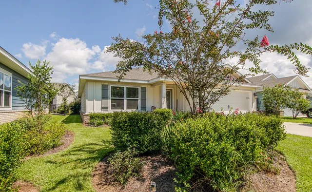 a front view of a house with garden