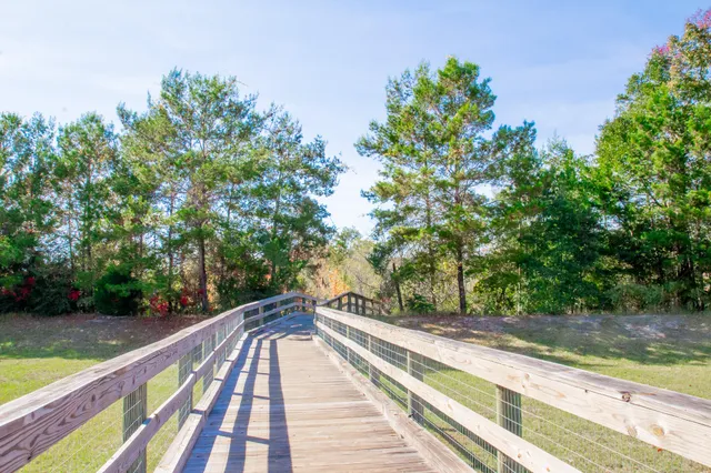 a balcony with wooden floor and trees
