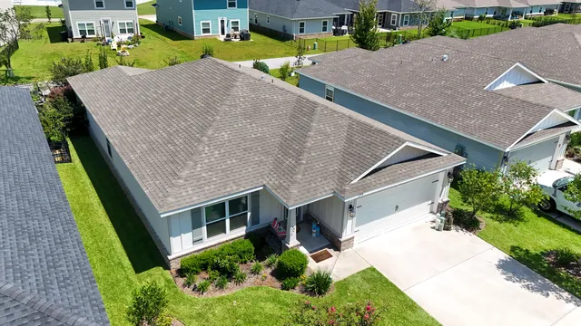 a aerial view of a house with a yard and plants