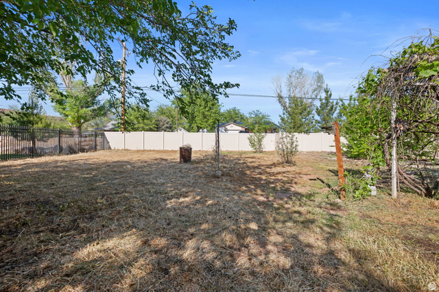 20 Valley Road Leeds, UT 84746 - Photo 31 of 57 Expansive outdoor space featuring a partial privacy fence and a partial wrought iron fence
