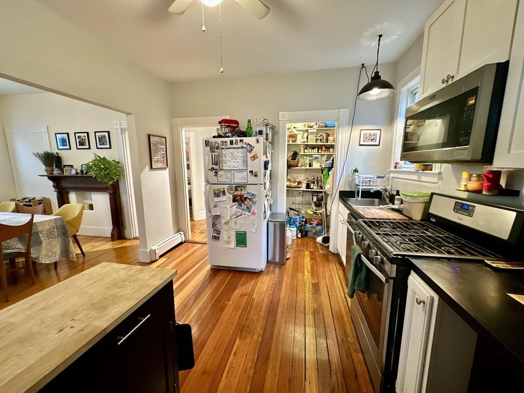 11 Sheridan Street, Unit 2 Boston, MA 02130 - Photo 5 of 17 a kitchen with stainless steel appliances granite countertop a stove and a wooden floors