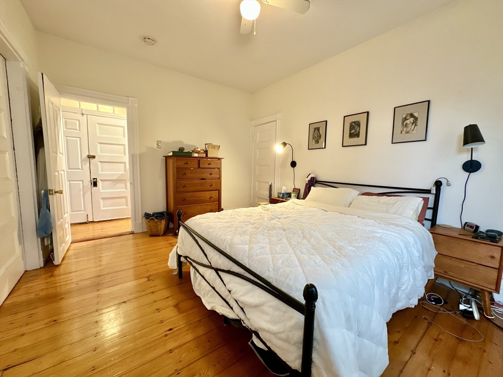 11 Sheridan Street, Unit 2 Boston, MA 02130 - Photo 7 of 17 a bedroom with a bed and a chandelier