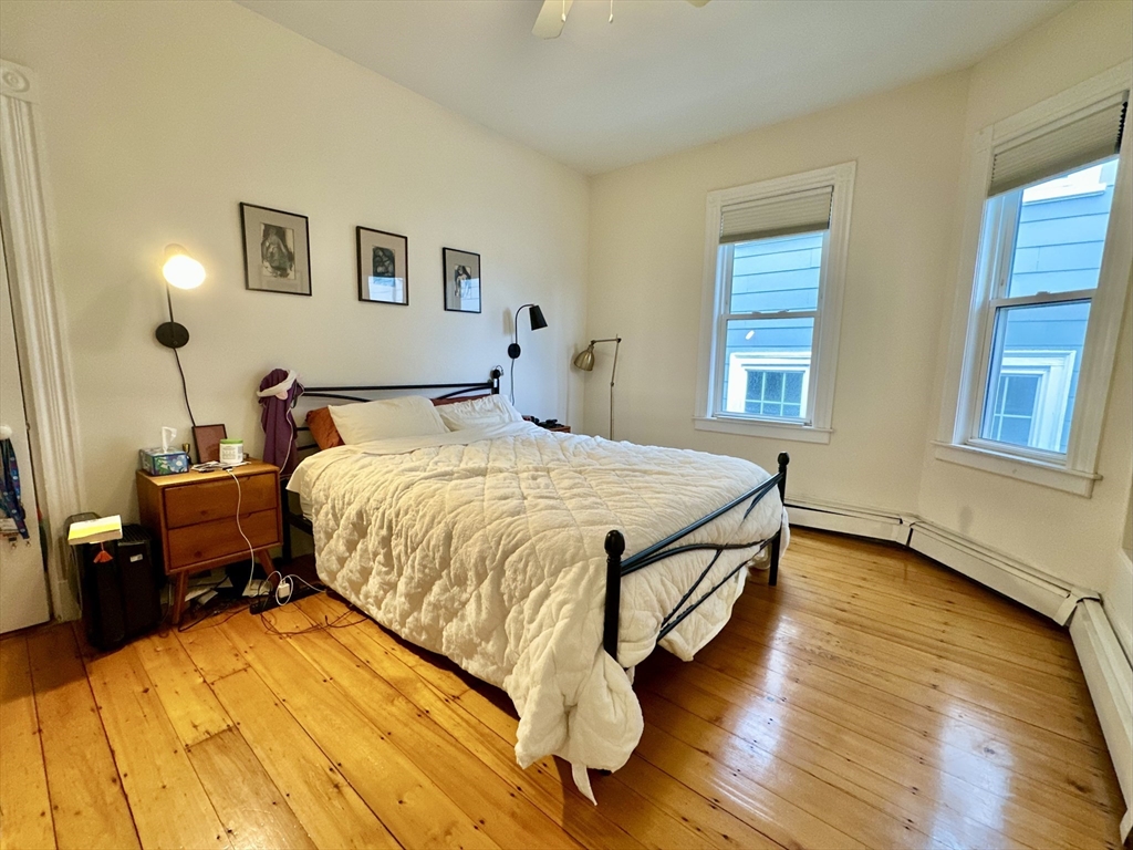 11 Sheridan Street, Unit 2 Boston, MA 02130 - Photo 8 of 17 a bed sitting in a bedroom next to a window