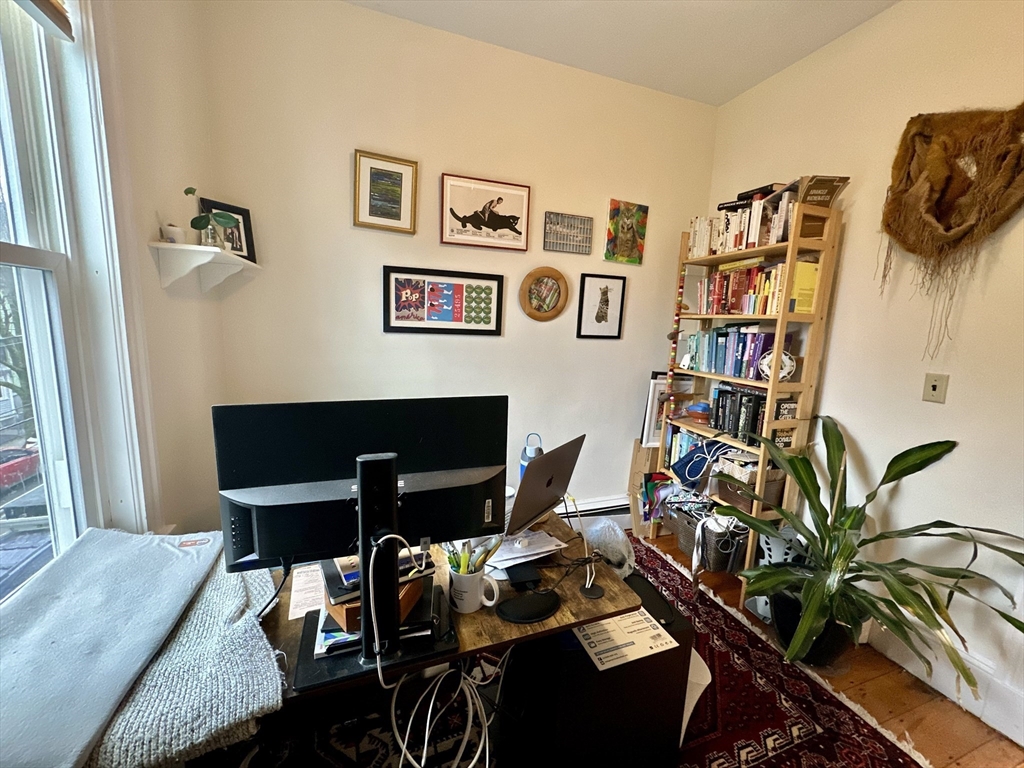 11 Sheridan Street, Unit 2 Boston, MA 02130 - Photo 10 of 17 a living room with furniture and book shelf