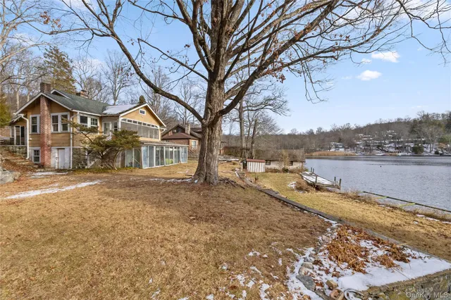 a view of a house with a yard and covered with snow