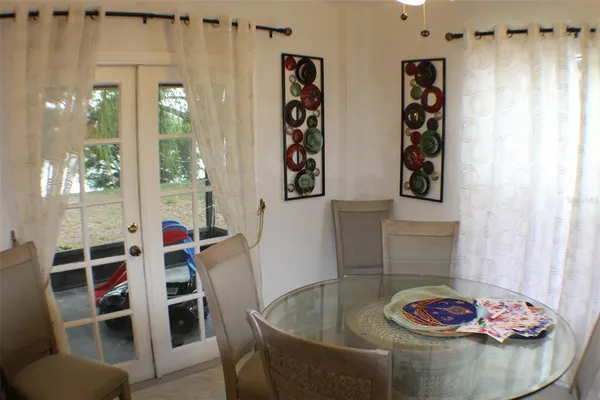 a view of a livingroom with furniture and chandelier fan