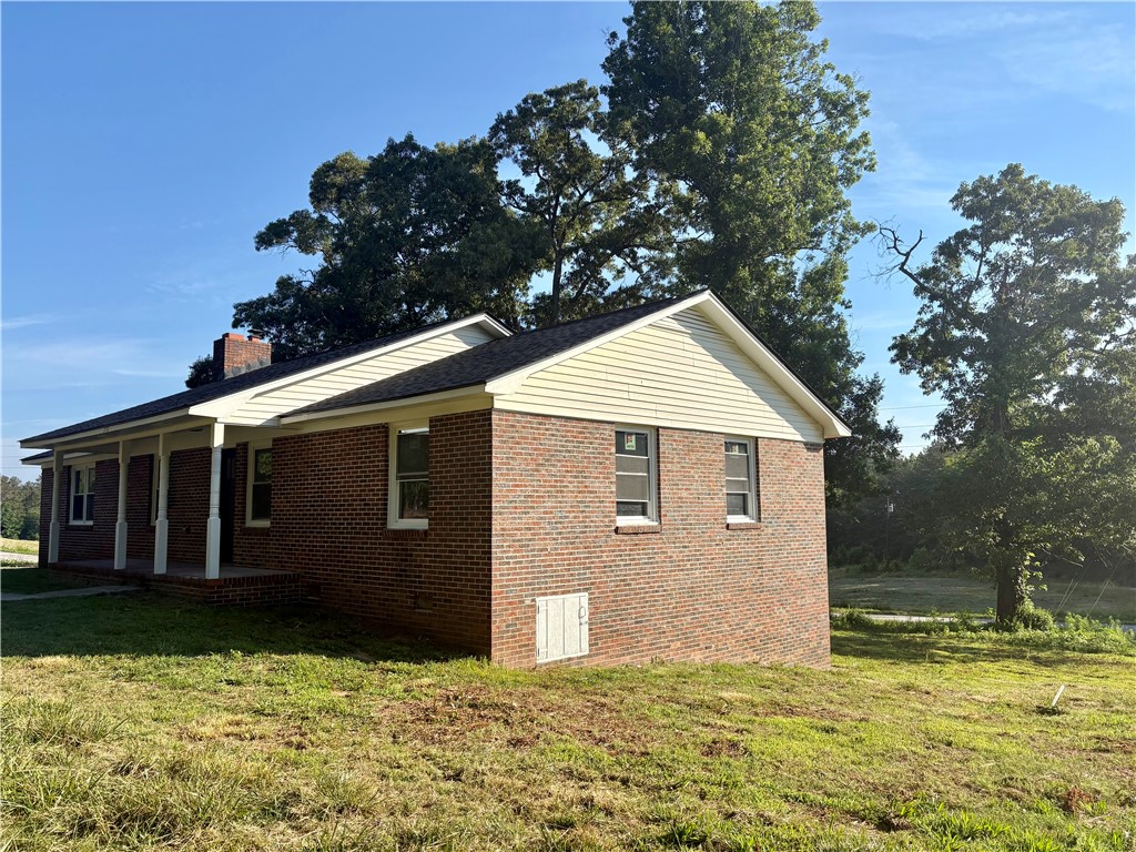 351 Randys Road Westminster, SC 29693 - Photo 3 of 30 A brick dwelling with a welcoming front porch offers a peaceful, treed setting.