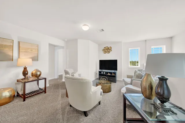 a living room with furniture a window and a lamp