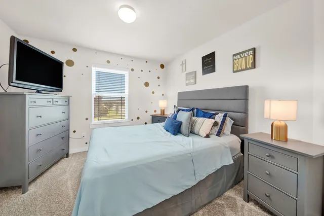 a bathroom with a sink a toilet a mirror and shower curtain