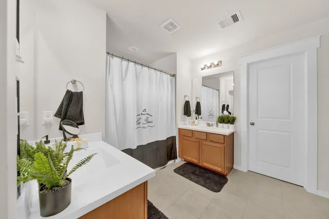 a bathroom with a double vanity sink and mirror