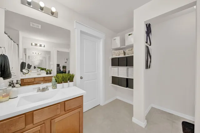 a kitchen with granite countertop kitchen island stainless steel appliances a refrigerator a stove a sink cabinets and a window