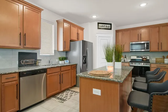 a living room with furniture a window and a flat screen tv