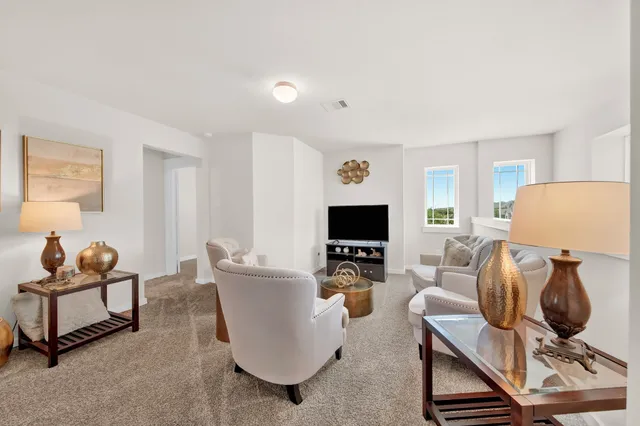 a large living room with stainless steel appliances granite countertop a couch and a view of living room