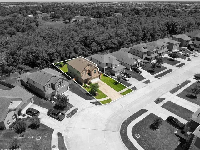 an aerial view of multiple houses with yard