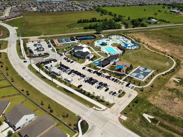 an aerial view of a house with a swimming pool