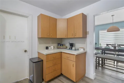 a kitchen with stainless steel appliances white cabinets and a stove top oven