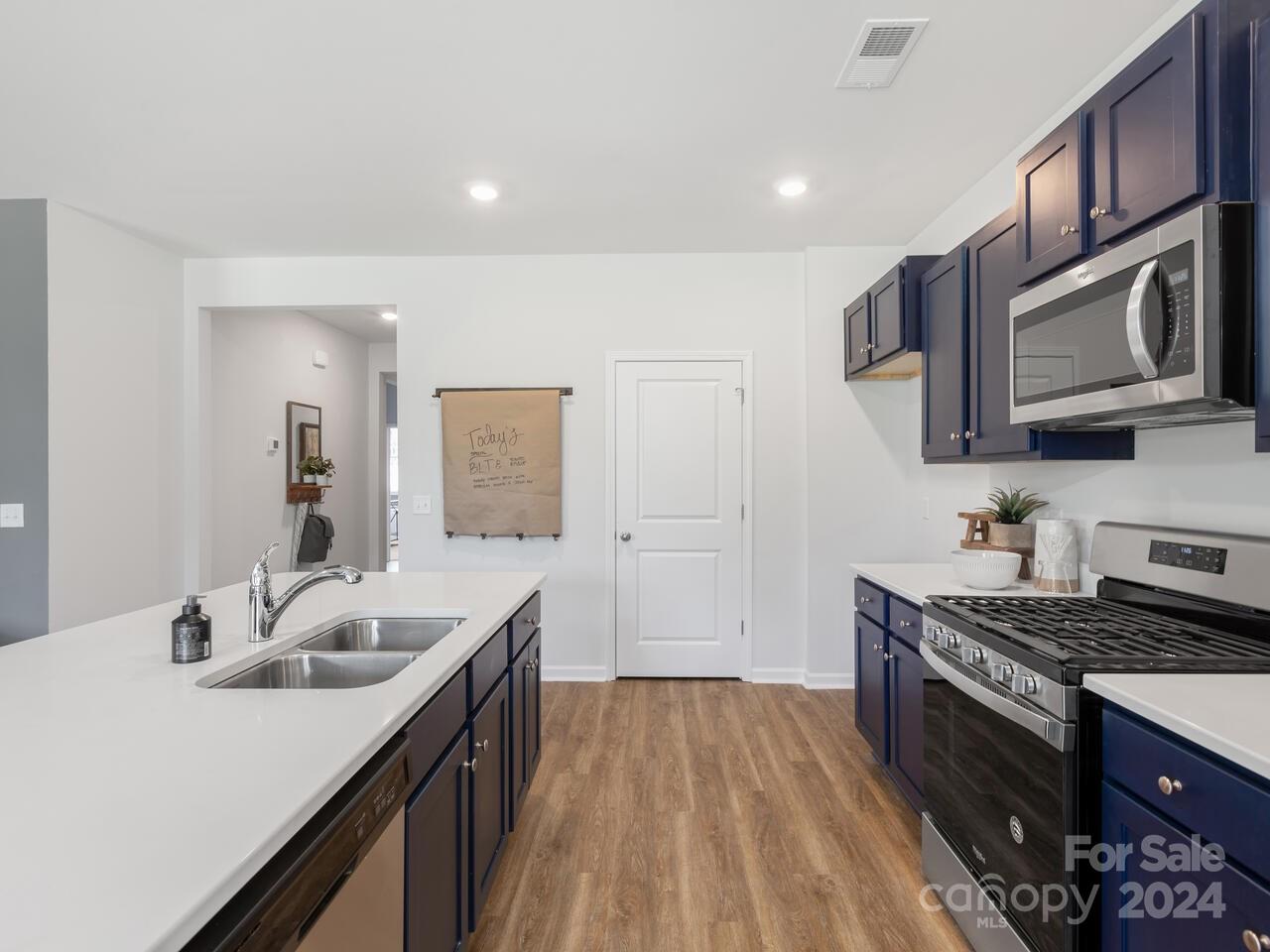63 Dandelion Road Fletcher, NC 28732 - Photo 7 of 27 a kitchen with stainless steel appliances a sink stove and cabinets