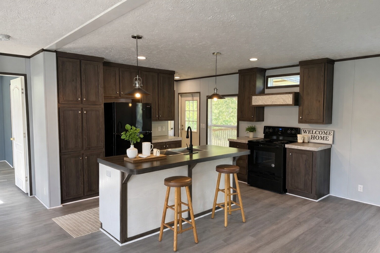 532 Pointe Lane Lafayette, TN 37083 - Photo 2 of 11 a kitchen with kitchen island granite countertop a sink cabinets and wooden floor