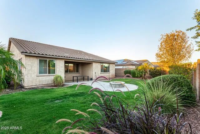 a view of an empty room with window and chandelier