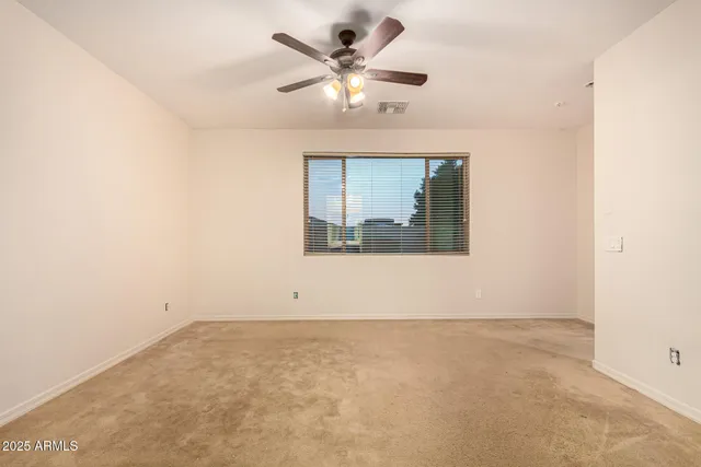 a view of a kitchen with refrigerator and cabinets