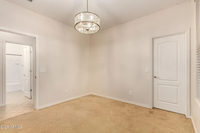 an empty room with a fan & a ceiling fan