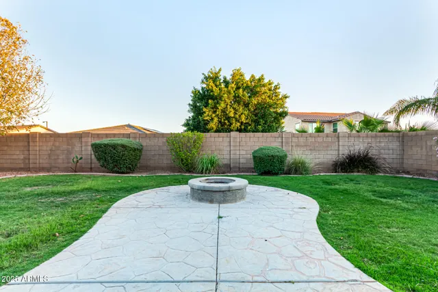 a view of a backyard with table and chairs and potted plants