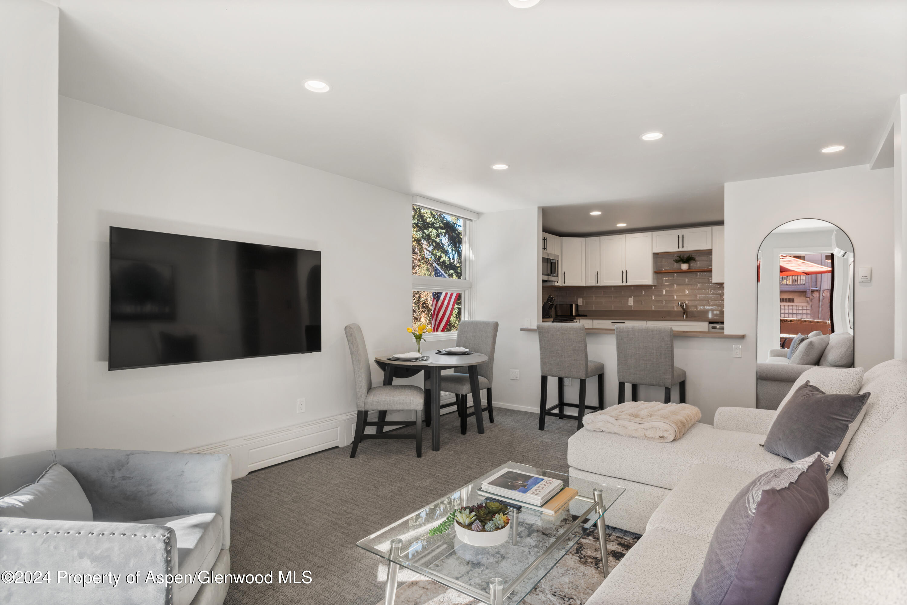 605 East Main Street, Unit 7 Aspen, CO 81611 - Photo 2 of 13 a living room with furniture and a flat screen tv