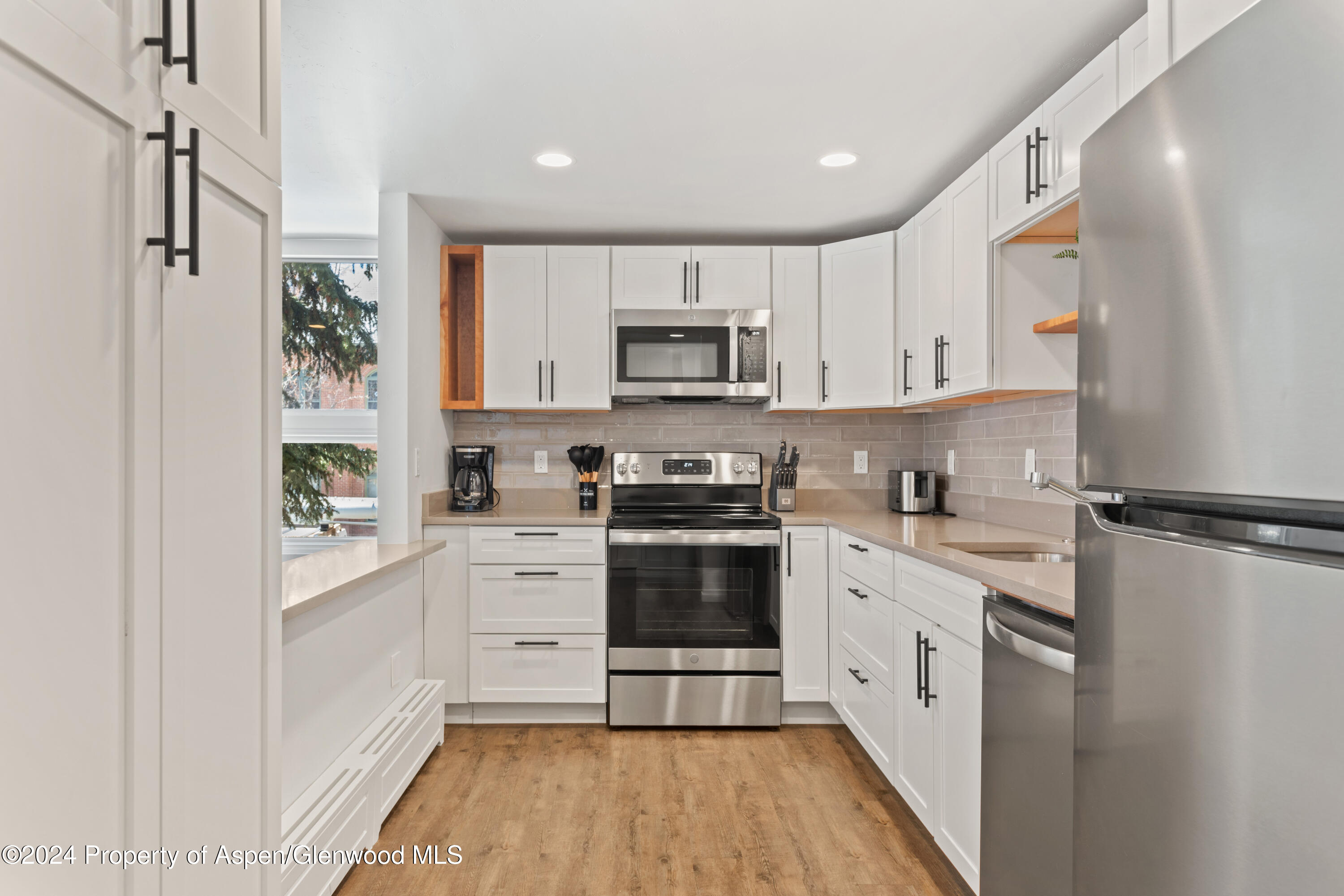 605 East Main Street, Unit 7 Aspen, CO 81611 - Photo 5 of 13 a kitchen with stainless steel appliances a stove a sink and a refrigerator