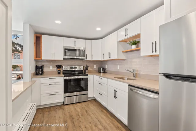 a kitchen with a white cabinets and white appliances