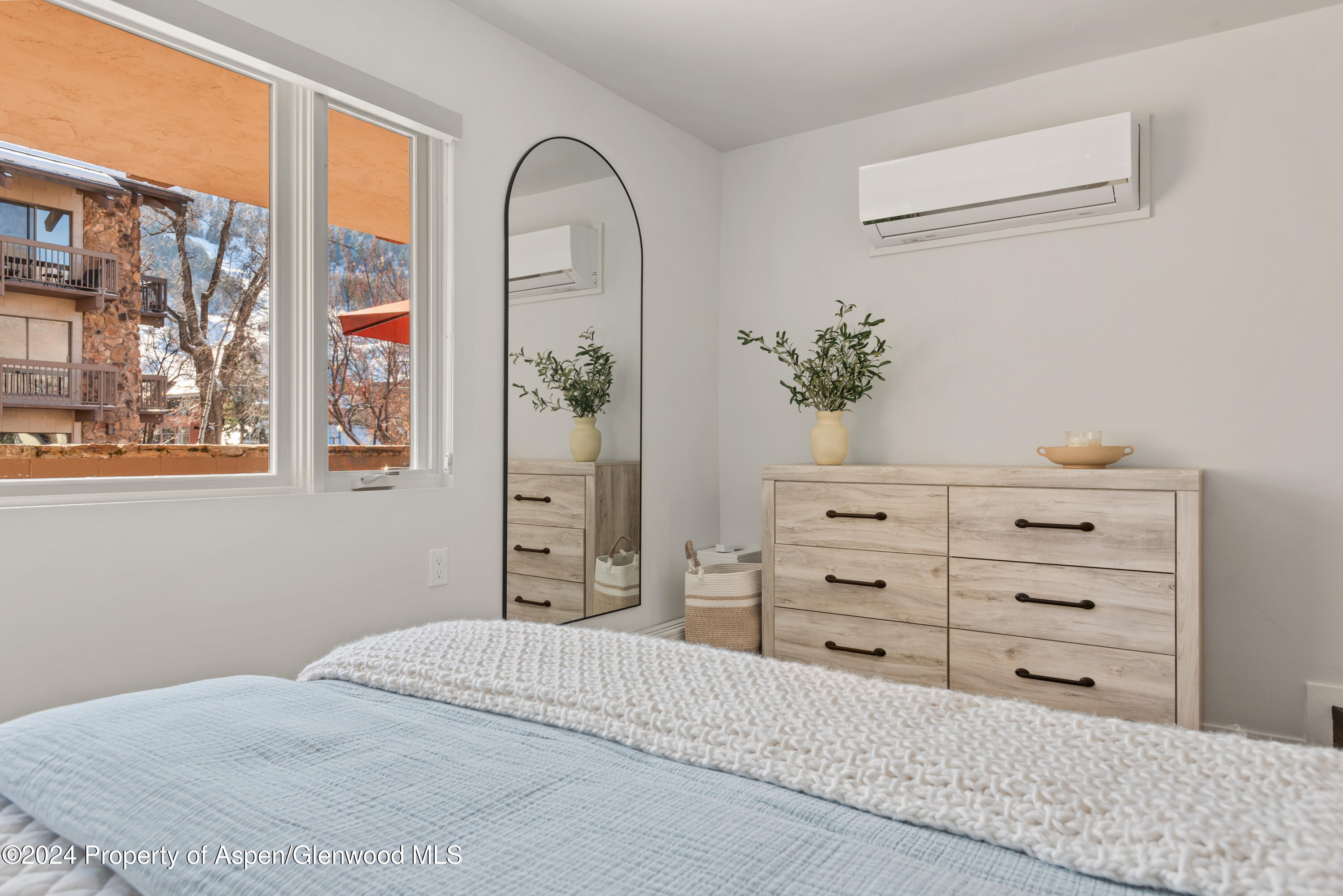 605 East Main Street, Unit 7 Aspen, CO 81611 - Photo 8 of 13 a bedroom with a bed and a potted plant