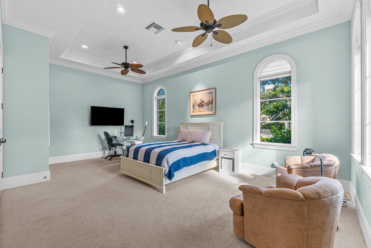 6103 North Ocean Boulevard Ocean Ridge, FL 33435 - Photo 12 of 53 a spacious bedroom with a bed and a couch