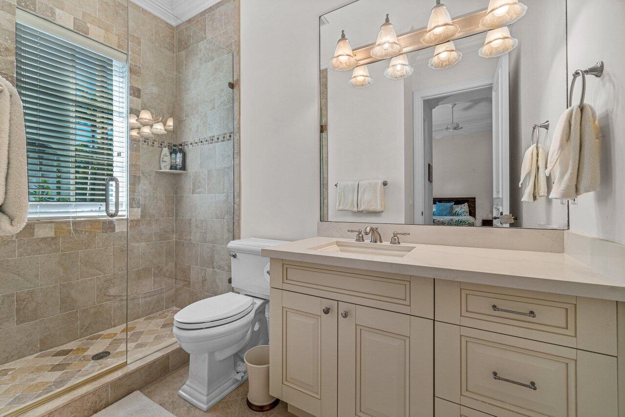 6103 North Ocean Boulevard Ocean Ridge, FL 33435 - Photo 14 of 53 a bathroom with a sink a toilet and a mirror